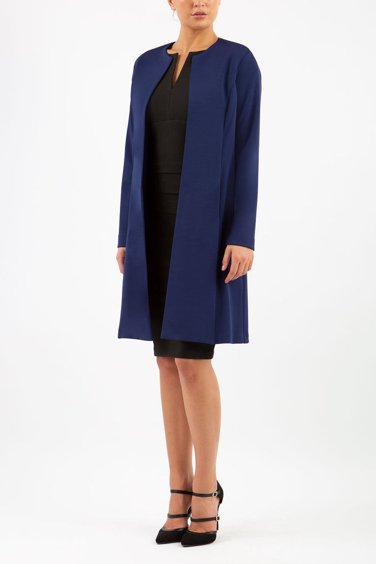 model wearing diva catwalk navy blue coat with long sleeves and a belt front