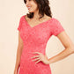 Model wearing the Diva Abberton Lace Sweetheart Neckline Pencil Dress in coral front 