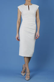 model is wearing diva catwalk seed fitzrovia sleeveless pencil dress in sandy cream front
