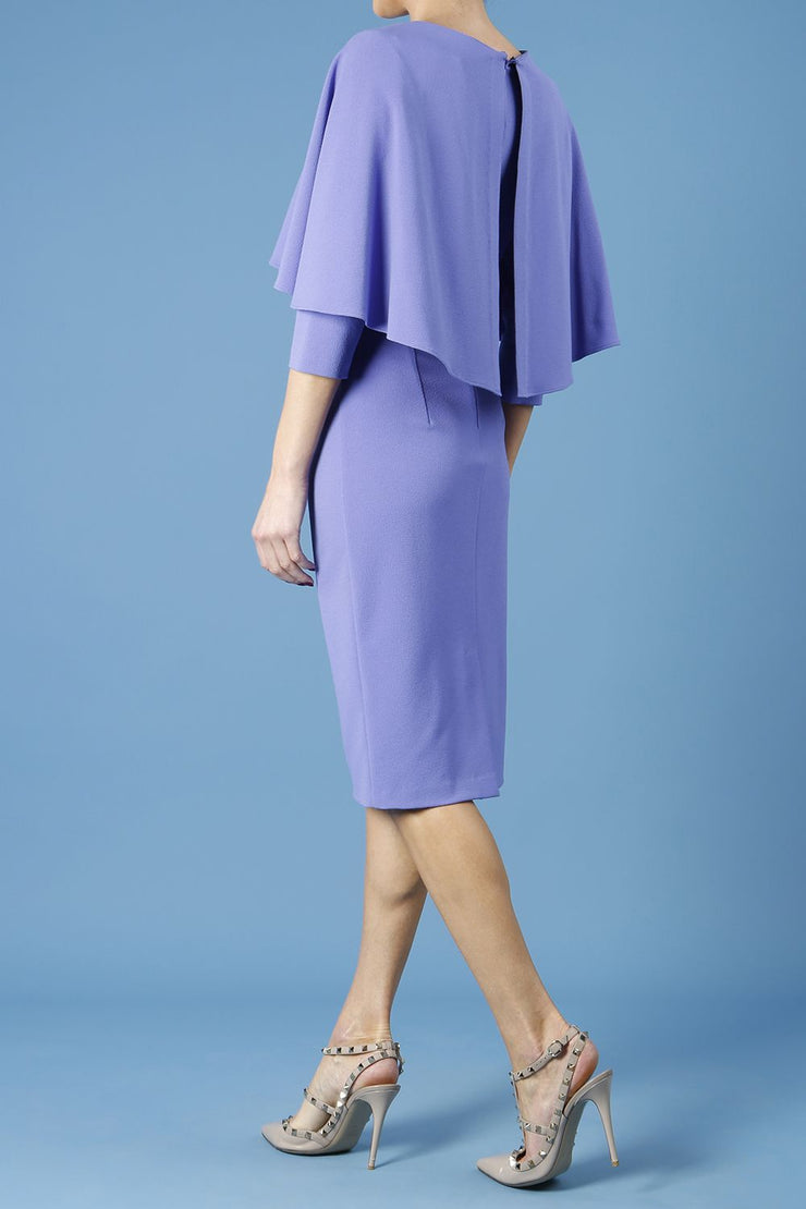 model wearing diva catwalk lizanne pencil-skirt dress with an attached wide cape detail and 3 4 sleeves in colour fusion indigo back