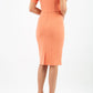 model wearing diva catwalk mitzi short sleeve pencil dress with square frilled neckline in dusty coral back