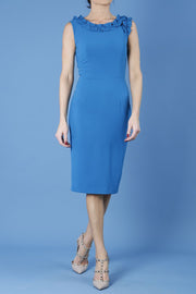brunette model is wearing diva catwalk odessa pencil sleeveless dress with frill detail on rounded neckline in tropic teal front