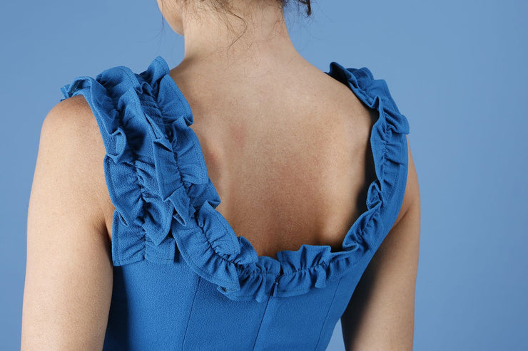 brunette model is wearing diva catwalk odessa pencil sleeveless dress with frill detail on rounded neckline in tropic teal back close up