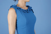 brunette model is wearing diva catwalk odessa pencil sleeveless dress with frill detail on rounded neckline in tropic teal front