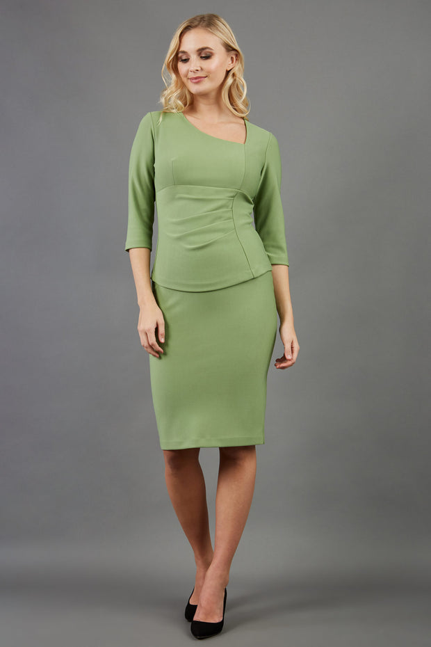blonde model is wearing diva catwalk pencil skirt in aspen green paired with courtney sleeved top front