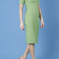 model is wearing diva catwalk seed barton short sleeve pencil dress with v-neck in citrus green front 