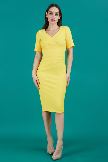 model is wearing diva catwalk seed barton short sleeve pencil dress with v-neck in daffodil yellow front 
