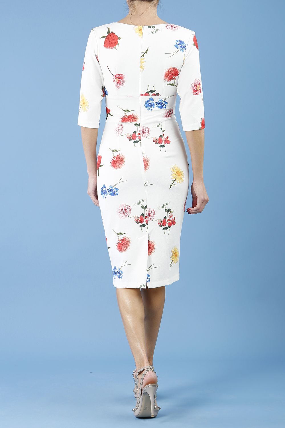 Model wearing the Diva Cynthia Floral Print dress with pleating across the front in buttercup print back