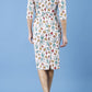 Model wearing the Diva Cynthia Floral Print dress with pleating across the front in linear tulip back