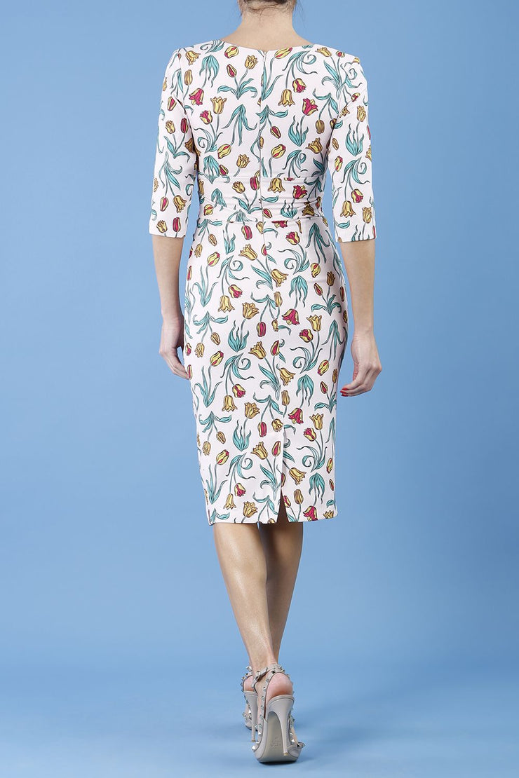 Model wearing the Diva Cynthia Floral Print dress with pleating across the front in linear tulip back