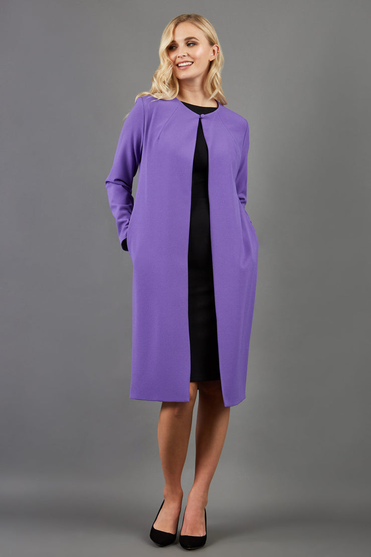 blonde model wearing the Diva Bliss Coat with round neckline in opulent violet front image