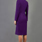 blonde model wearing the Diva Silverstone Coat with V neckline in imperial purple back image