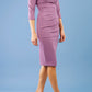 brunette model wearing diva catwalk best selling lydia pencil sleeved dress with slit at the neckline and pleating across the tummy in colour purple heart front side