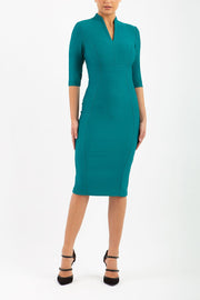 model is wearing diva catwalk seed amalfi plain pencil dress with high v-neck and sleeves in pacific green front
