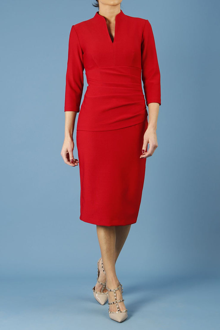 model is wearing diva catwalk seed holsworthy pencil dress with pleating on a tummy area and high neck with sleeves in cardinal red front