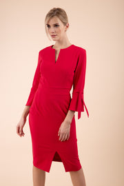 blonde model wearing diva catwalk zoe 3 4 sleeve formal dress with a split rounded neckline and split on skirt in ruby red colour front