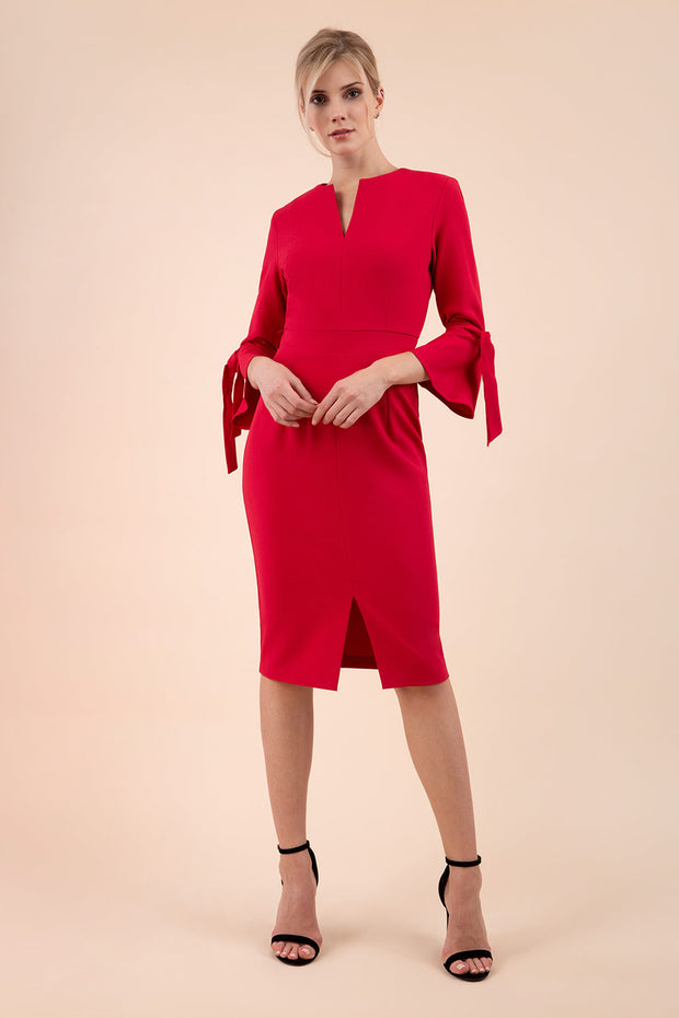 blonde model wearing diva catwalk zoe 3 4 sleeve formal dress with a split rounded neckline and split on skirt in ruby red colour front