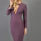 model is wearing diva catwalk fifi pencil skirt dress with three quarter flute sleeve and rounded neckline with a cut out at the front in mauve