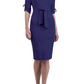 brunette model wearing diva catwalk tryst pencil navy blue dress with sleeves and belt detail at the front with rounded neckline front