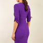 brunette model wearing diva catwalk tryst pencil purple dress with sleeves and belt detail at the front with rounded neckline back