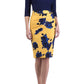 A model wearing a knee-length pencil skirt with a yellow base and blue floral print, paired with a navy top.
