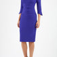 blonde model wearing seed tuscany pencil fitted dress in palace blue colour with a split in the neckline and split detail on sleeves front