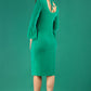 A brunette model is wearing a velvet long bell sleeve pencil dress maternity style in green colour back
