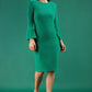 A brunette model is wearing a velvet long bell sleeve pencil dress maternity style in green colour front 