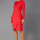 brunette model wearing diva catwalk pencil skirt dress sleeved with  pleating on side in electric red colour front