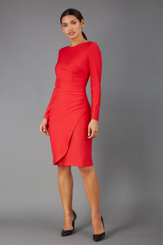 brunette model wearing diva catwalk pencil skirt dress sleeved with  pleating on side in electric red colour front