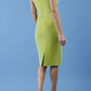 brunette model is wearing diva catwalk velvet pencil dress with V-neck and wrap skirt in tropical green back