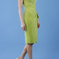 brunette model is wearing diva catwalk velvet pencil dress with V-neck and wrap skirt in tropical green front