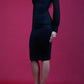 brunette model wearing diva catwalk black pencil dress with long sleeves knee length and mesh detail sleeves front