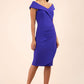 brunette model wearing diva catwalk pencil skirt dress sleeveless with lowered neckline and pleating on side in spectrum indigo colour front