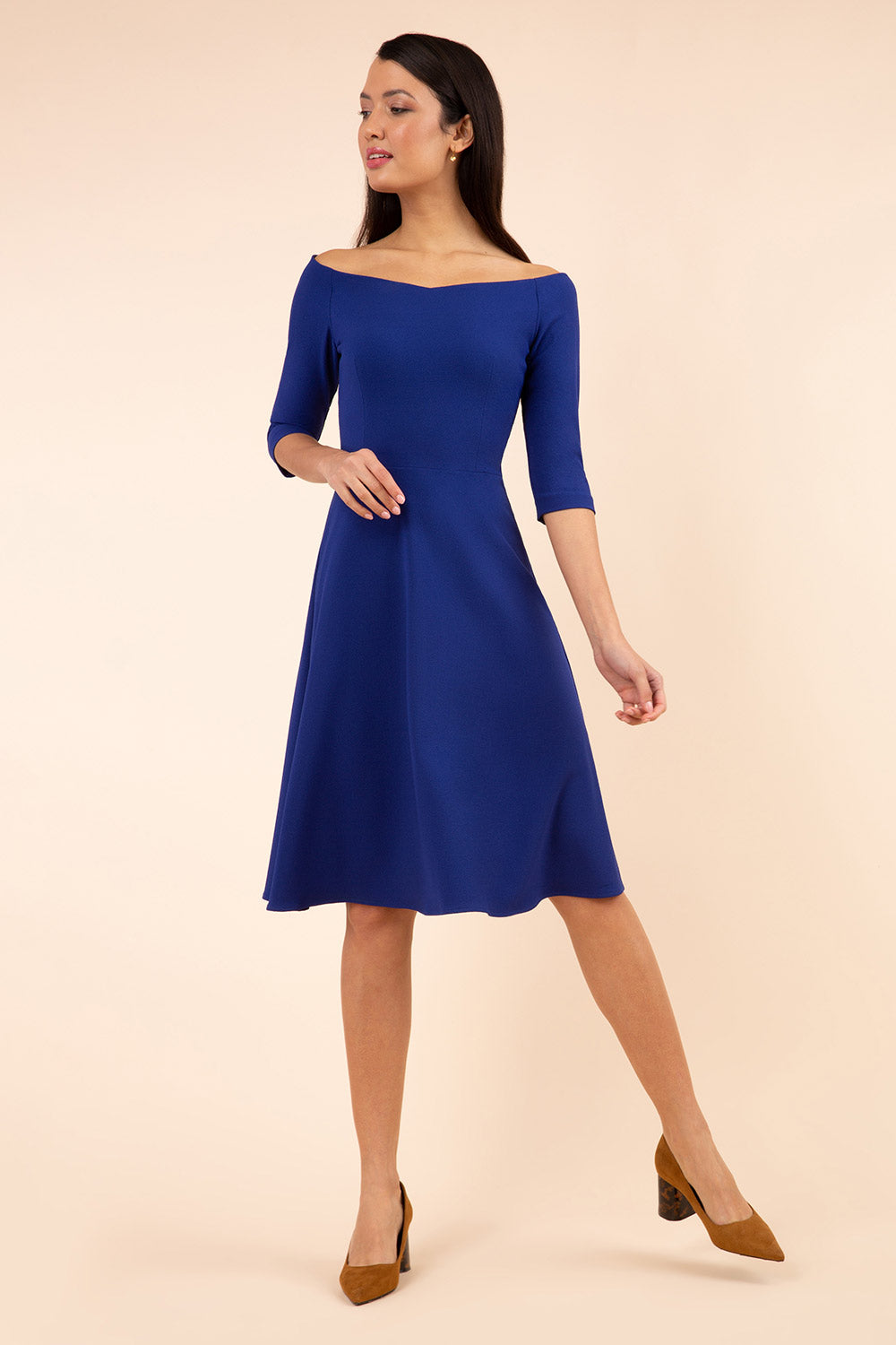 brunette model is wearing diva catwalk off shulder swing a-line islay dress with sleeves in oxford blue front
