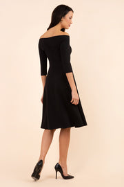 brunette model is wearing diva catwalk off shulder swing a-line islay dress with sleeves in black back