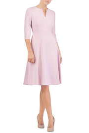  blonde model wearing diva catwalk romney three quarter sleeve swing dress with a band in dawn pink front