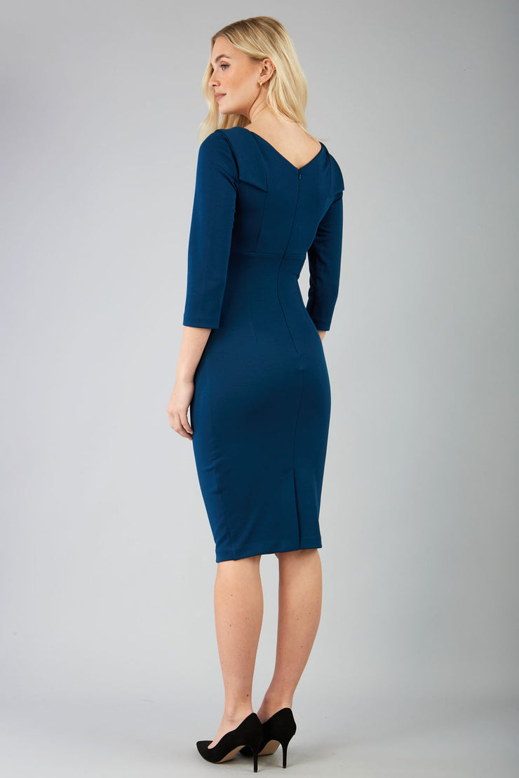 model wearing diva catwalk york pencil-skirt dress with sleeves and rounded folded collar and plearing across the tummy area in glorious teal colour back