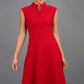 Brunette Model is wearing a sleeveless swing high neck dress with high neck in cardinal red by Diva Catwalk front