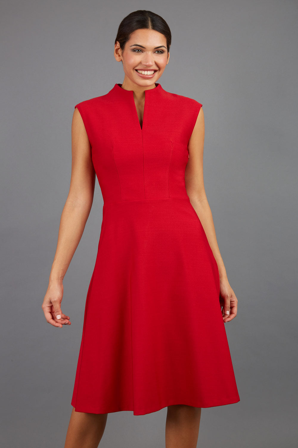 Brunette Model is wearing a sleeveless swing high neck dress with high neck in cardinal red by Diva Catwalk front