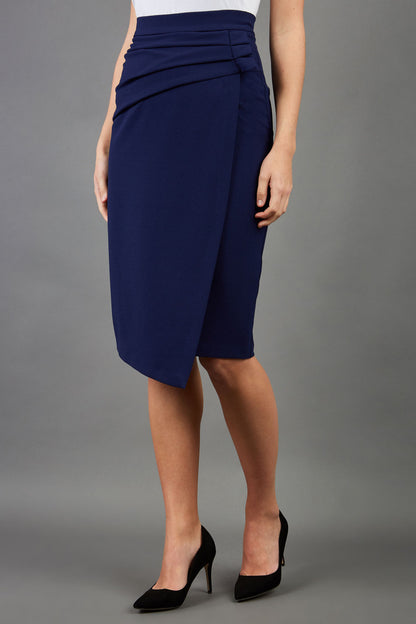 model is wearing diva catwalk antibe pencil asymmetric skirt with pleating at the front in navy front