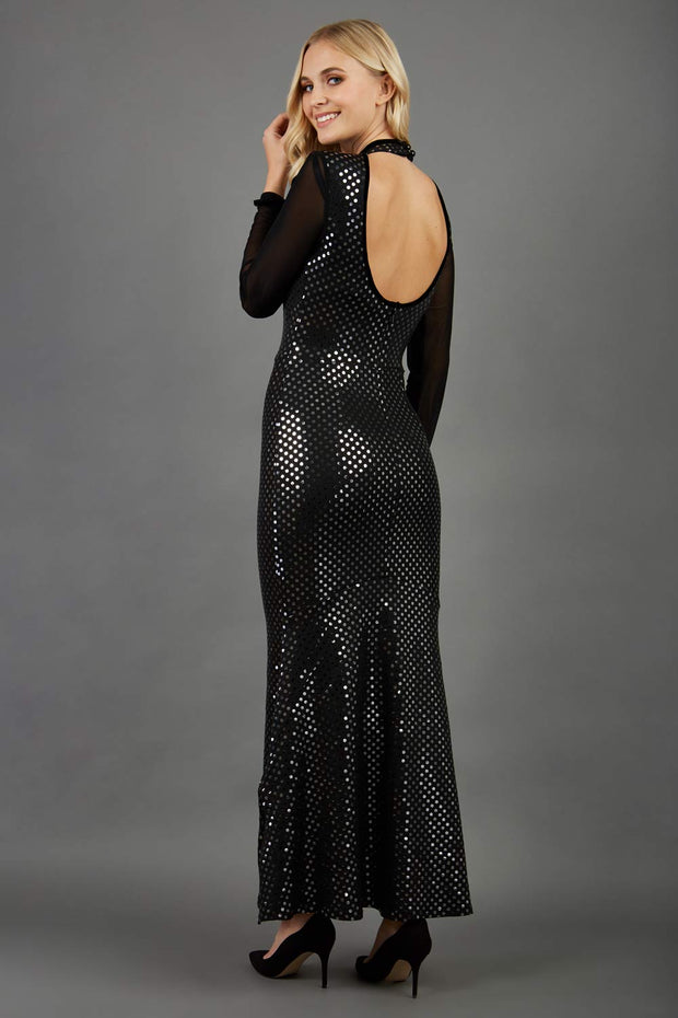 Blonde Model wearing a long full length metallic sparkle dress by Diva Catwalk back