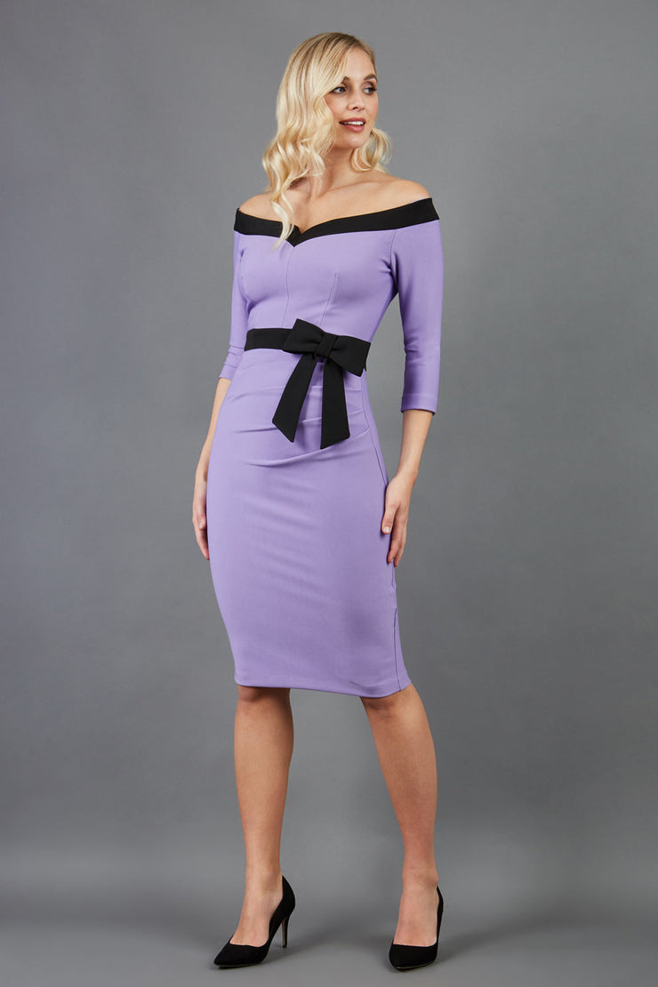 blonde model wearing diva catwalk luma pencil skirt dress with contrasting bow off shoulder with sleeves in lilac wisteria front