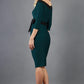 blonde model wearing diva catwalk luma pencil skirt dress with contrasting bow off shoulder with sleeves in forest green front