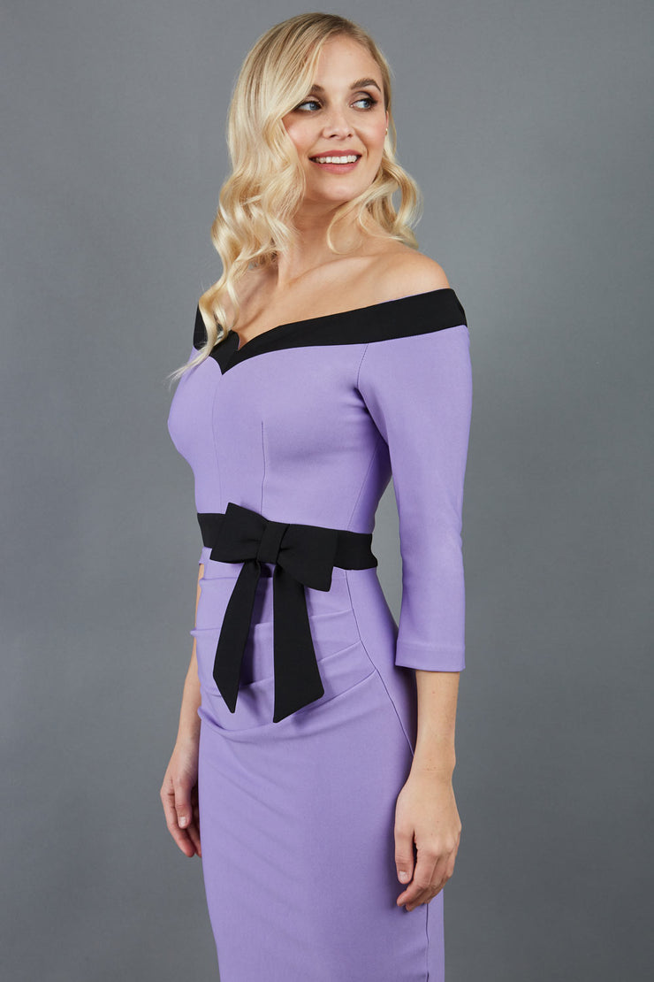 blonde model wearing diva catwalk luma pencil skirt dress with contrasting bow off shoulder with sleeves in lilac wisteria front