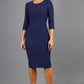 brunette model is wearing diva catwalk seed rosa plain dress with rounded neckline in navy blue front