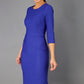 brunette model is wearing diva catwalk seed rosa plain dress with rounded neckline in palace blue front