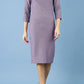 brunette model is wearing diva catwalk seed rosa plain dress with rounded neckline in dusky lilac front