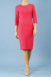 brunette model is wearing diva catwalk seed rosa plain dress with rounded neckline in opera pink front