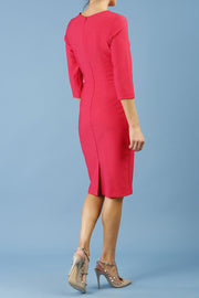 brunette model is wearing diva catwalk seed rosa plain dress with rounded neckline in opera pink back